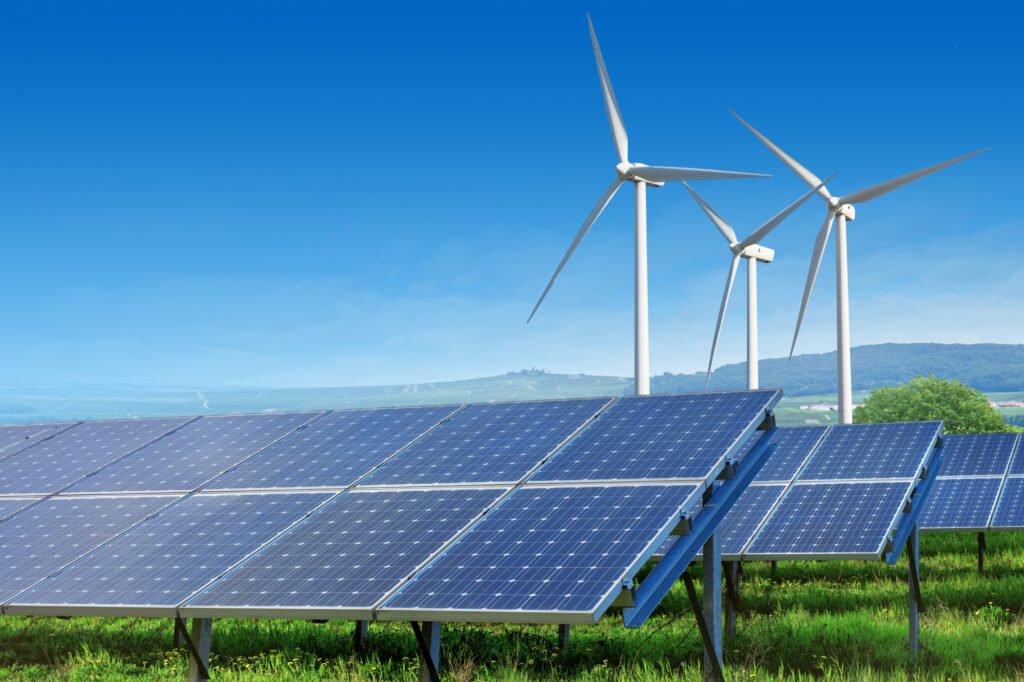 solar panels and wind turbines under blue sky