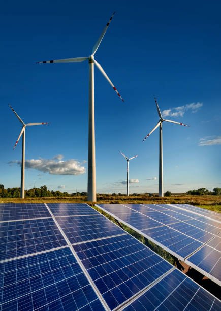 wind turbines and solar panels closeup on sky background